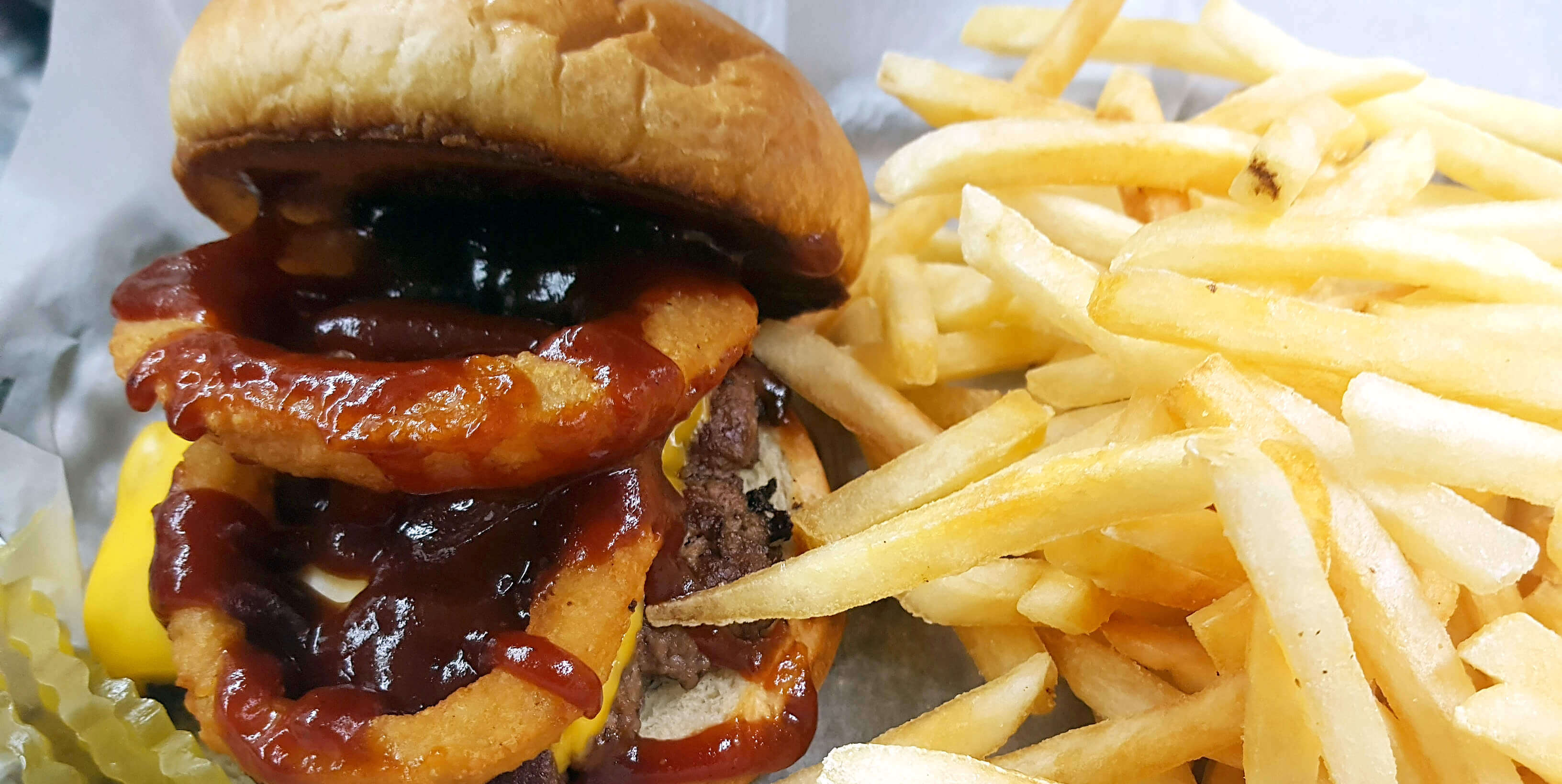 BBQ Onion Ring Burger and Fries from Main Gate Bar & Grill
